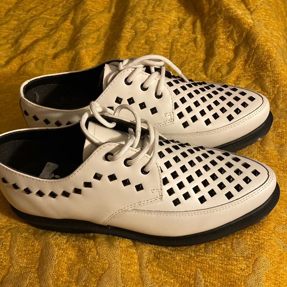 New White Dr. Martens with black studs.
